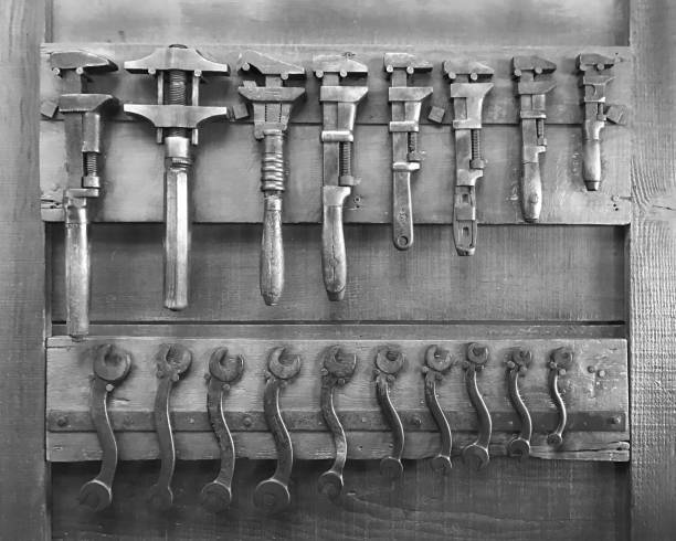 istock Mechanical tools on wooden wall (wrench and plier) - black and white tone 901215574