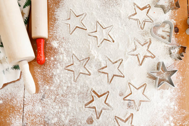 istock Heart and star shaped cookie cutters made by professional unknown cook, rolling pins for making thin dough. Home made Christmas cookies ready to be baked. Gingerbread made of different forms. 901216408