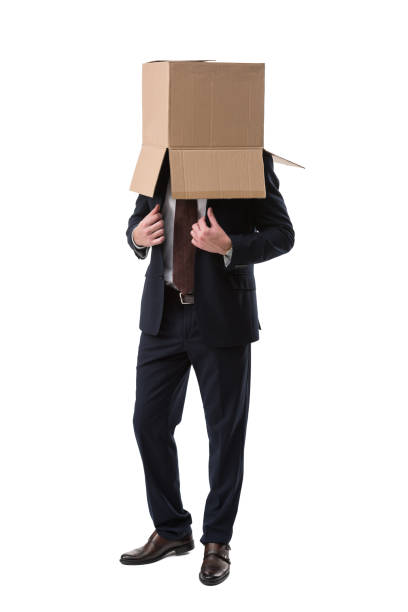 istock confident businessman with box on head 901221096
