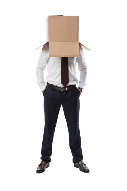 istock serious businessman with box on head 901221188