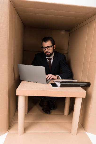 istock businessman with paperwork and laptop 901224246