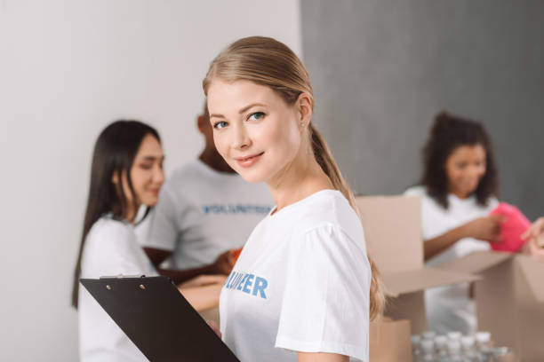 istock female volunteer with clipboard 901228016