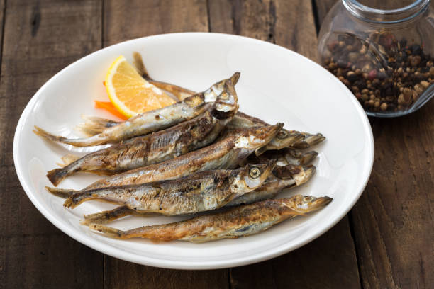 istock Grilled fish capelin or shishamo on white plate 901228746