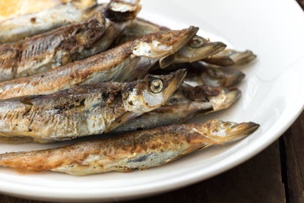 istock Grilled fish capelin or shishamo on white plate 901228748