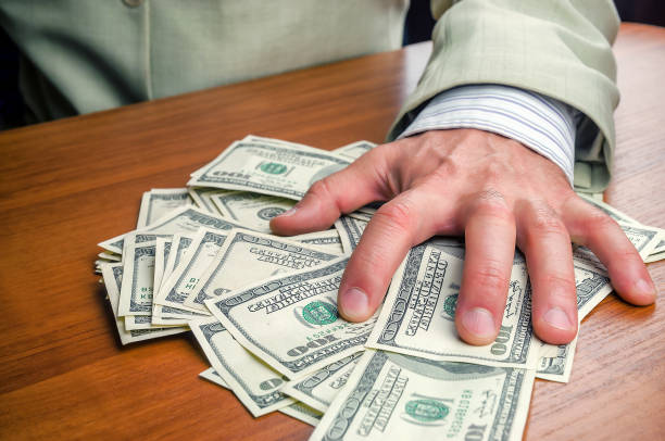 istock businessman takes money (dollars) 901234388