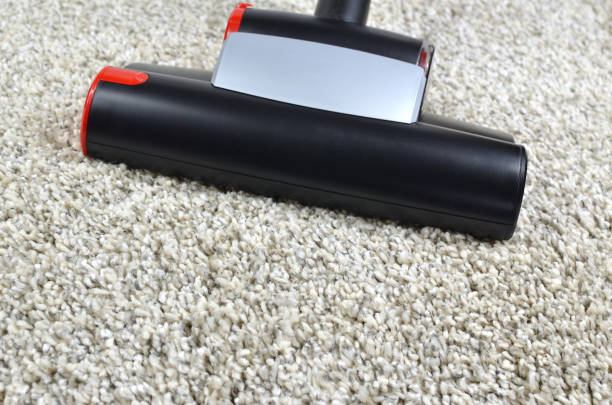 istock Cleaning carpet with vacuum cleaner dust brush 901234748