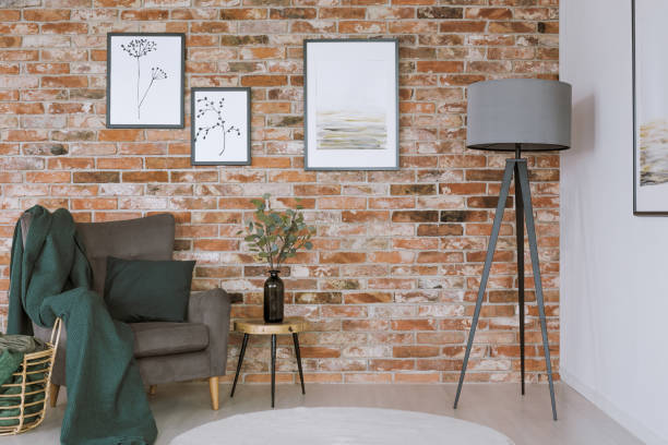 istock Grey armchair against brick wall 901235280