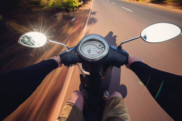 istock Rider driving scooter on an asphalt road. Motion blurred backgro 901235346