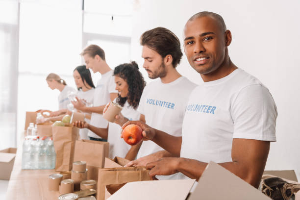 istock volunteer packing food into bag 901235368