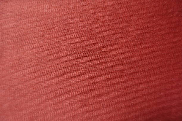 istock Surface of orange jersey fabric from above 901236346