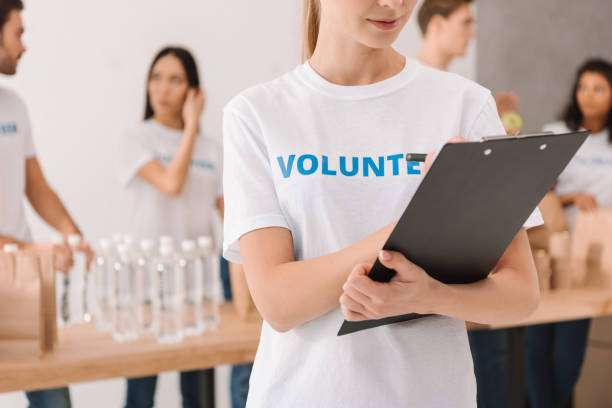 istock volunteer writing in clipboard 901237442