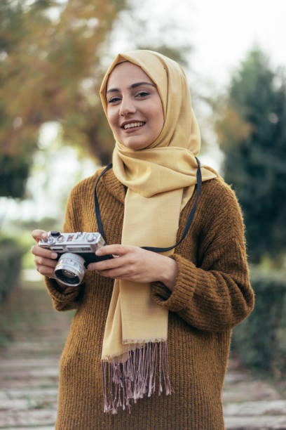 Young muslim woman photographer young muslim woman photographer muslim photographer stock pictures, royalty-free photos & images