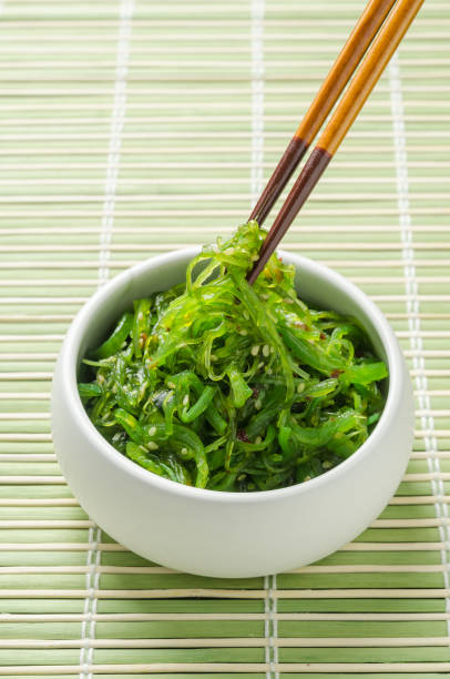 istock Spicy Seaweed Salad with chopsticks on bamboo background. 901240110