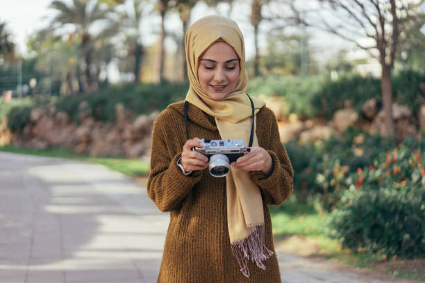 Young muslim woman photographer Young muslim woman photographer muslim photographer stock pictures, royalty-free photos & images
