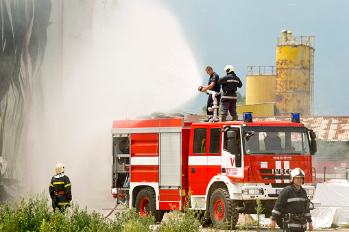 Sofia: Firefighters extinguish fire disaster in a warehouse. Fire fighting in an industrial area.