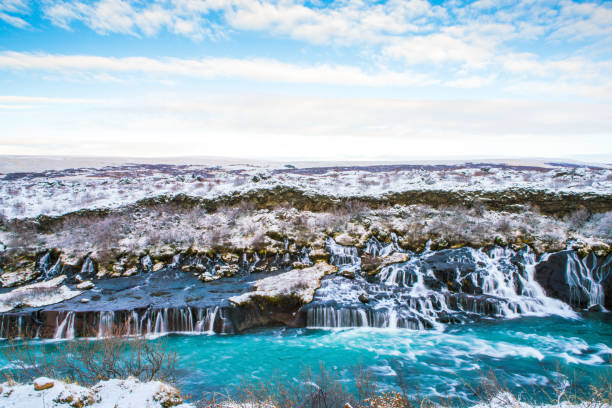 Hraunfossar Waterfall, Iceland Hraunfossar, a waterfall formed by rivulets streaming over Hallmundarhraun, a lava field from volcano lying under the glacier Langjokull, and pour into the Hvita river, Iceland hraunfossar stock pictures, royalty-free photos & images
