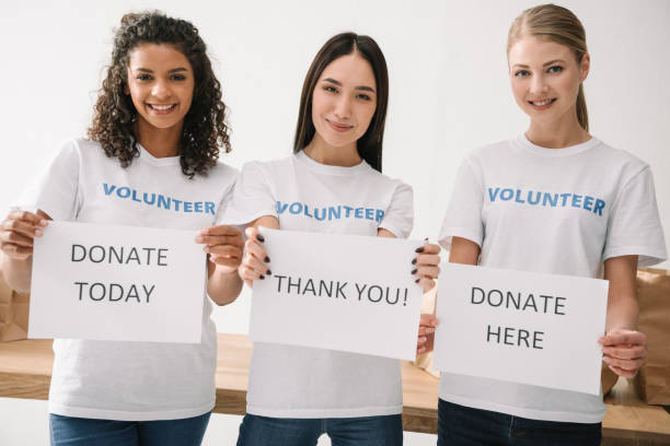 istock female volunteers holding placards 901252148