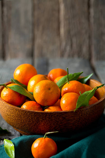 istock mandarins in a wooden bowl 901253360