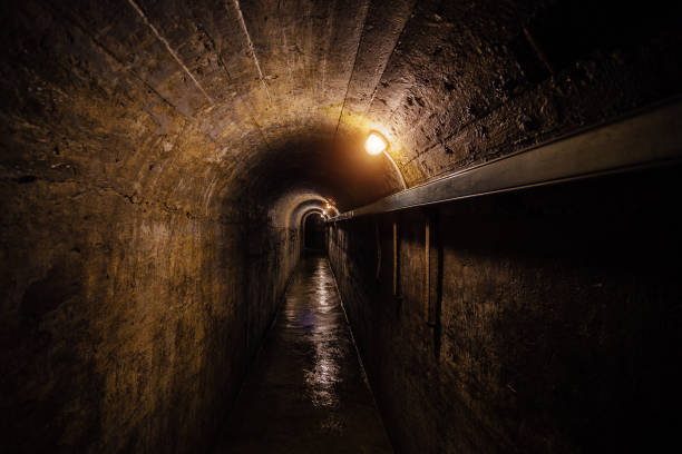 istock Dark corridor of old underground Soviet bunker under military artillery fortification 901254114