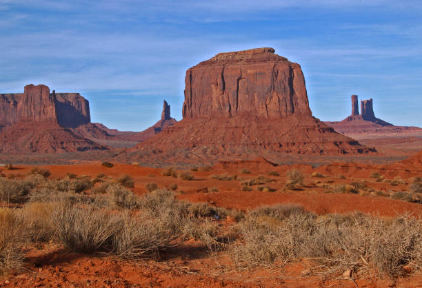Monument Valley Splendor Near the Utah and Arizona border is the awe inspiring splendor of the Monument Valley Navajo Tribal Park. You will recognize the area immediately as the back drop settings for many famous Westerns filmed in the area where such stars as John Wayne, Gary Cooper, Clint Eastwood and Tom Hanks have appeared in movies with Monument Valley setting the landscape. With December temperatures in the 50's on this visit, it proved to be an ideal crisp, clear day to photography the beauty of this area. kayenta photos stock pictures, royalty-free photos & images