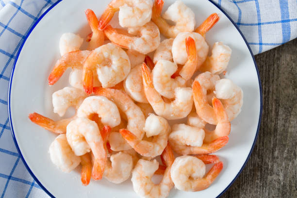istock frozen shrimps on wooden surface 901261450