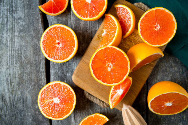 red oranges on wooden surface red oranges on wooden surface freshly squeezed stock pictures, royalty-free photos & images