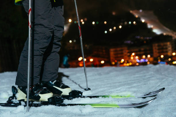 istock ski legs close up with snowed mount in evening on background 901265300