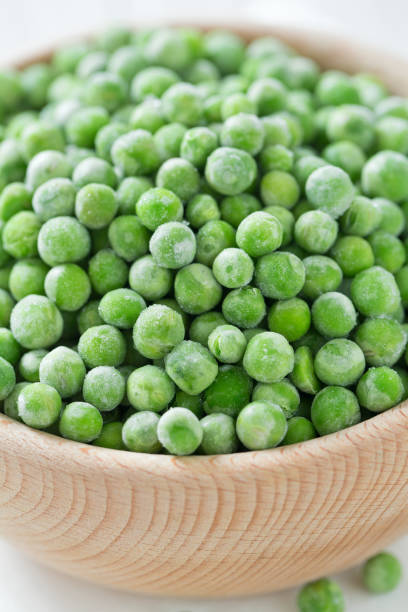 istock frozem peas on wooden surface 901266004