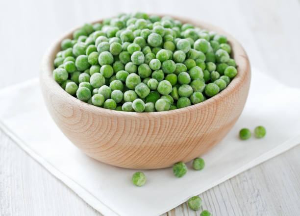 istock frozem peas on wooden surface 901266006