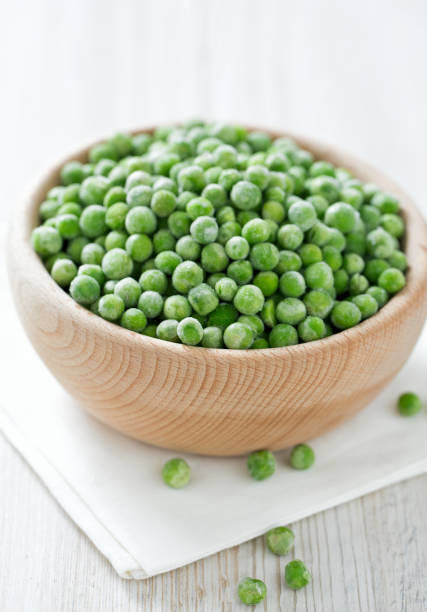 istock frozem peas on wooden surface 901266102