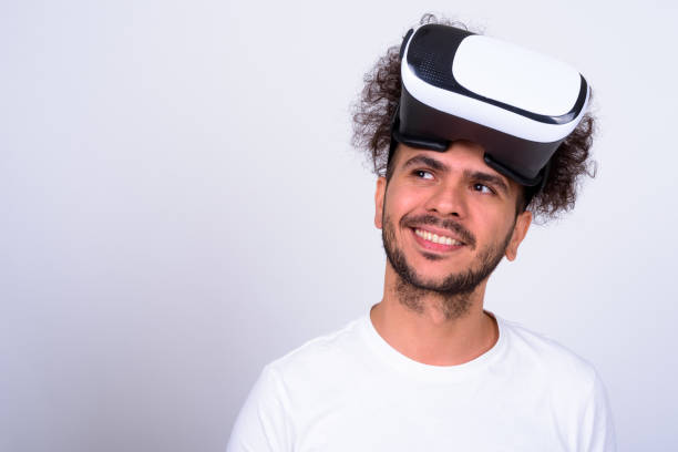 istock Studio Shot Of Man Against White Background Using VR Glasses 901269360