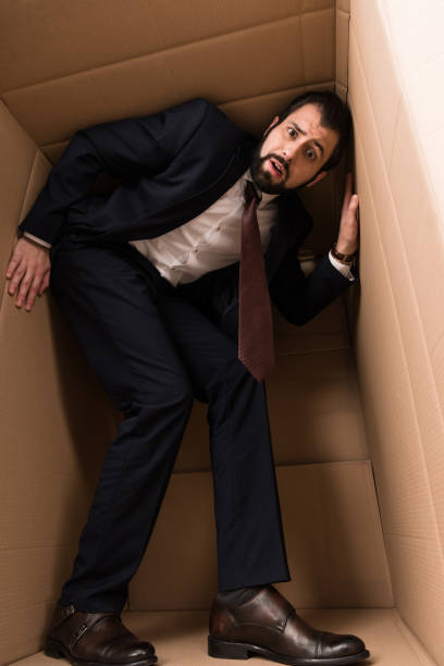 istock businessman with claustrophobia inside a box 901269928
