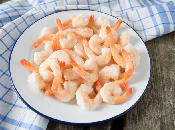 istock frozen shrimps on wooden surface 901270196