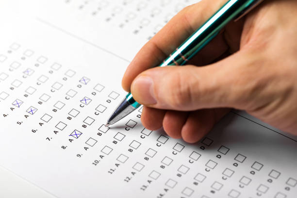 istock student hand with pen fill in exam test answer sheet 901270394