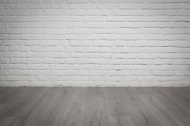 istock Old white brick wall and wood floor background 901270464