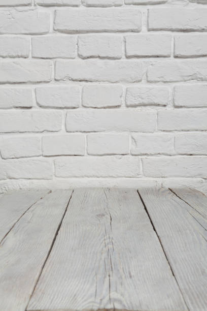 istock Old white brick wall and wood floor background 901270524