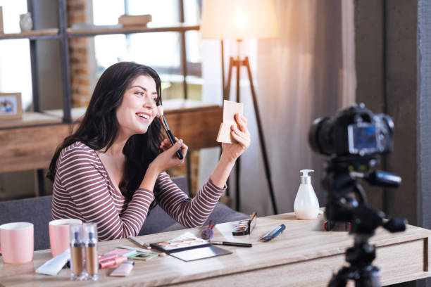 istock Cheerful attractive woman putting on make up 901273406