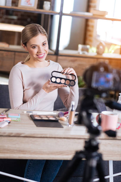istock Positive delighted woman holding eyeshadow palette 901273930