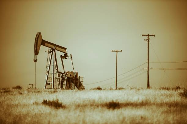 Iron Pumpjack on California Desert. Oil Industry Theme. Sepia Color Grading