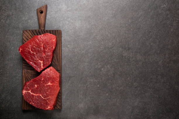 istock Raw marbled meat Steak ribeye on dark background. Angus meat. Top view 901284320
