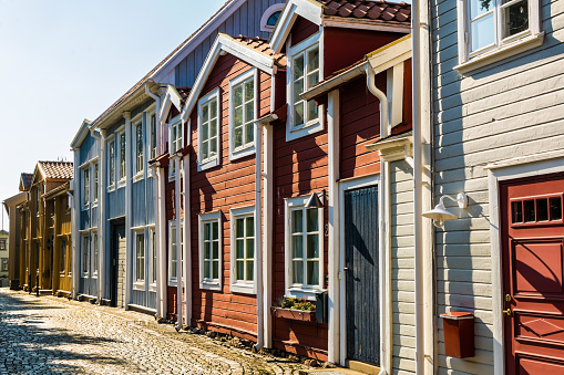 Row of characteristic wooden swedish houses on little town street. Summer, sunny day.