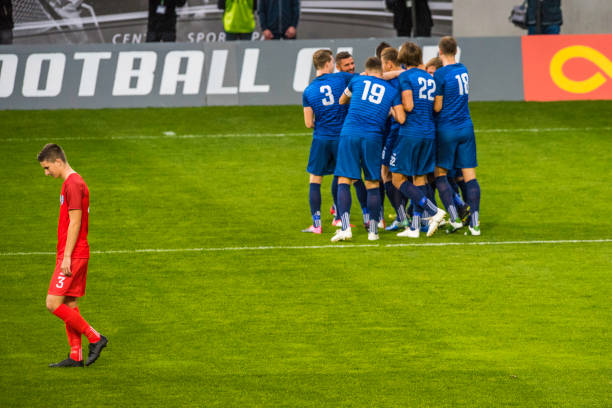 istock Soccer team in blue celebrating a goal 901288752