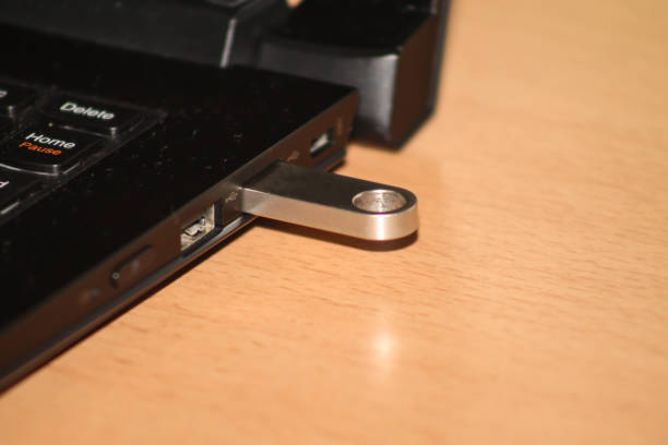istock Silver sleek and stylish USB drive sticked in laptop.2 901300602