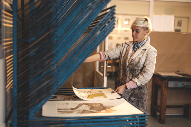 istock Craftswoman working applying dark ink on mould surface 901307768