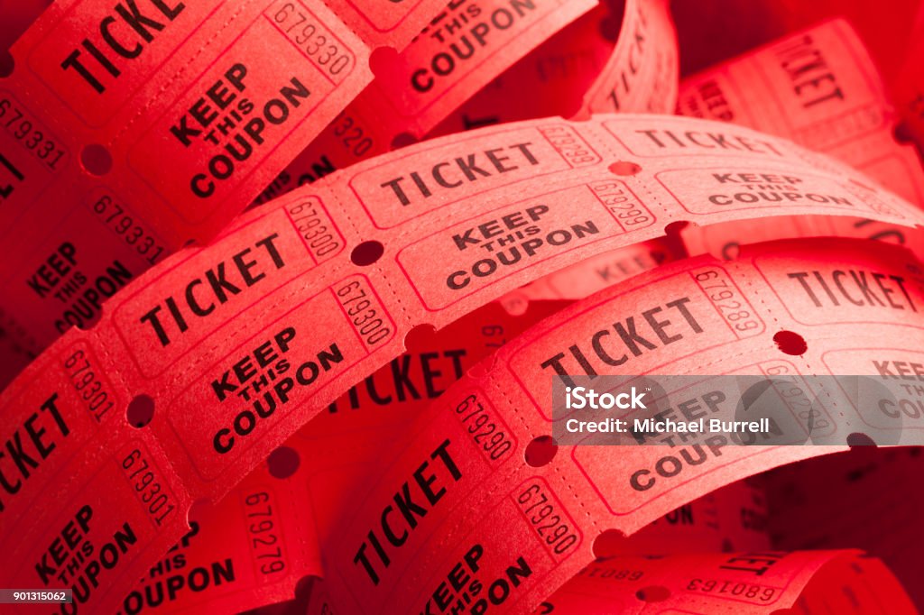 Messy Ticket Roll Unwound Messy Roll of Red Tickets Piled Up. Raffle Ticket Stock Photo