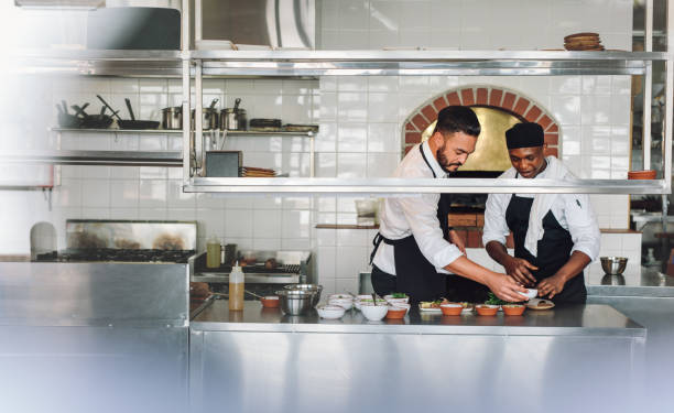 istock Chefs cooking food at commercial kitchen 901315528