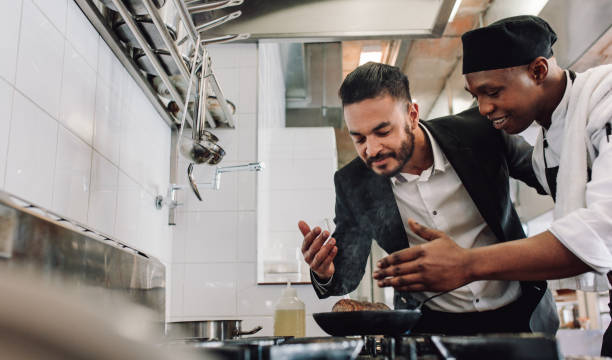 istock Manager smelling the aroma of food with chef 901317880