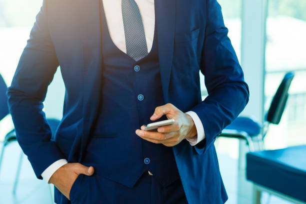 istock Professional businessman using mobile or smartphone and holding coffee young manager drinking 901318128