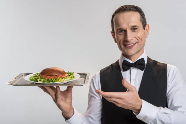 istock Positive good looking male waiter bringing order 901326888