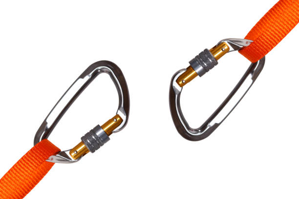Two carabiners isolated A set of two carabiners with orange nylon webbing straps attached carabina stock pictures, royalty-free photos & images